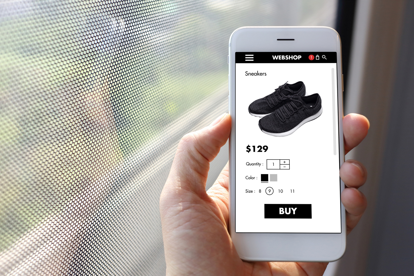 Hand Holding Smartphone with Displayed Sneaker Shop